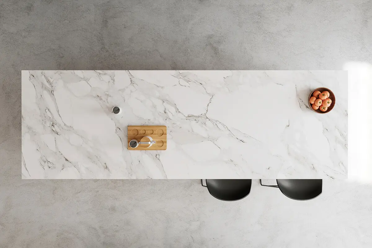 Modern kitchen island with stools and fruit.