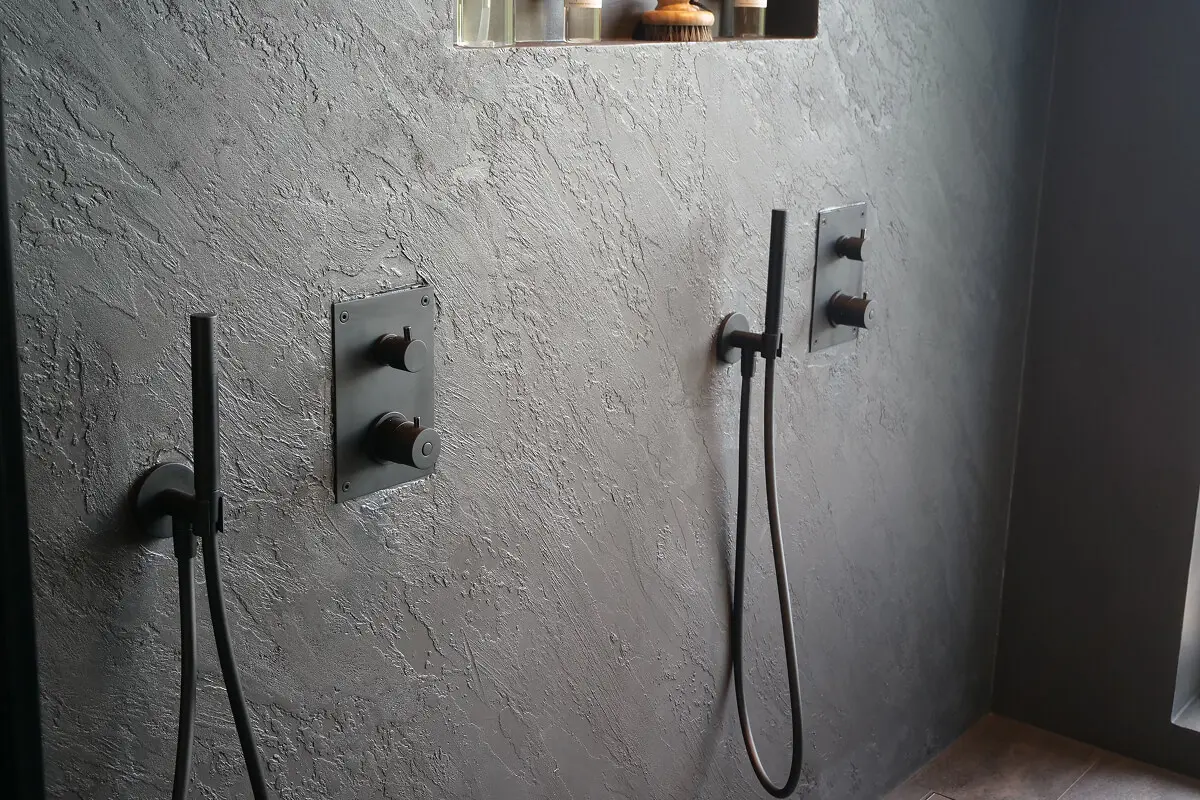 Modern shower with dual fixtures and controls.